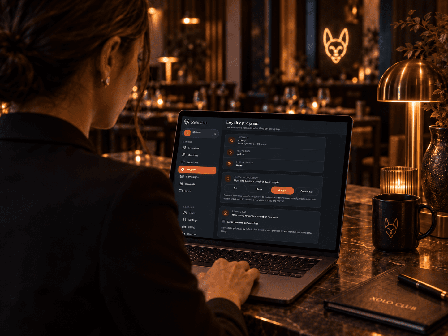 An owner working in the Xolo Club dashboard on a laptop
