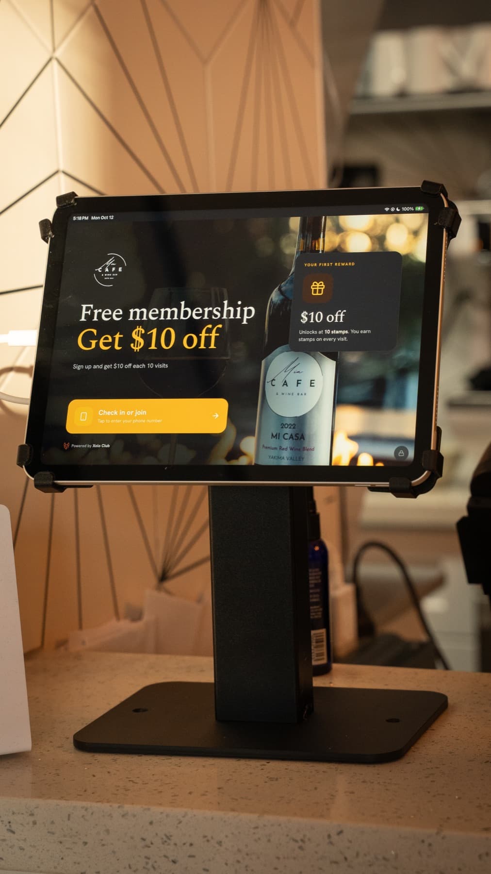 A Xolo Club kiosk on a café counter, showing the venue’s membership offer
